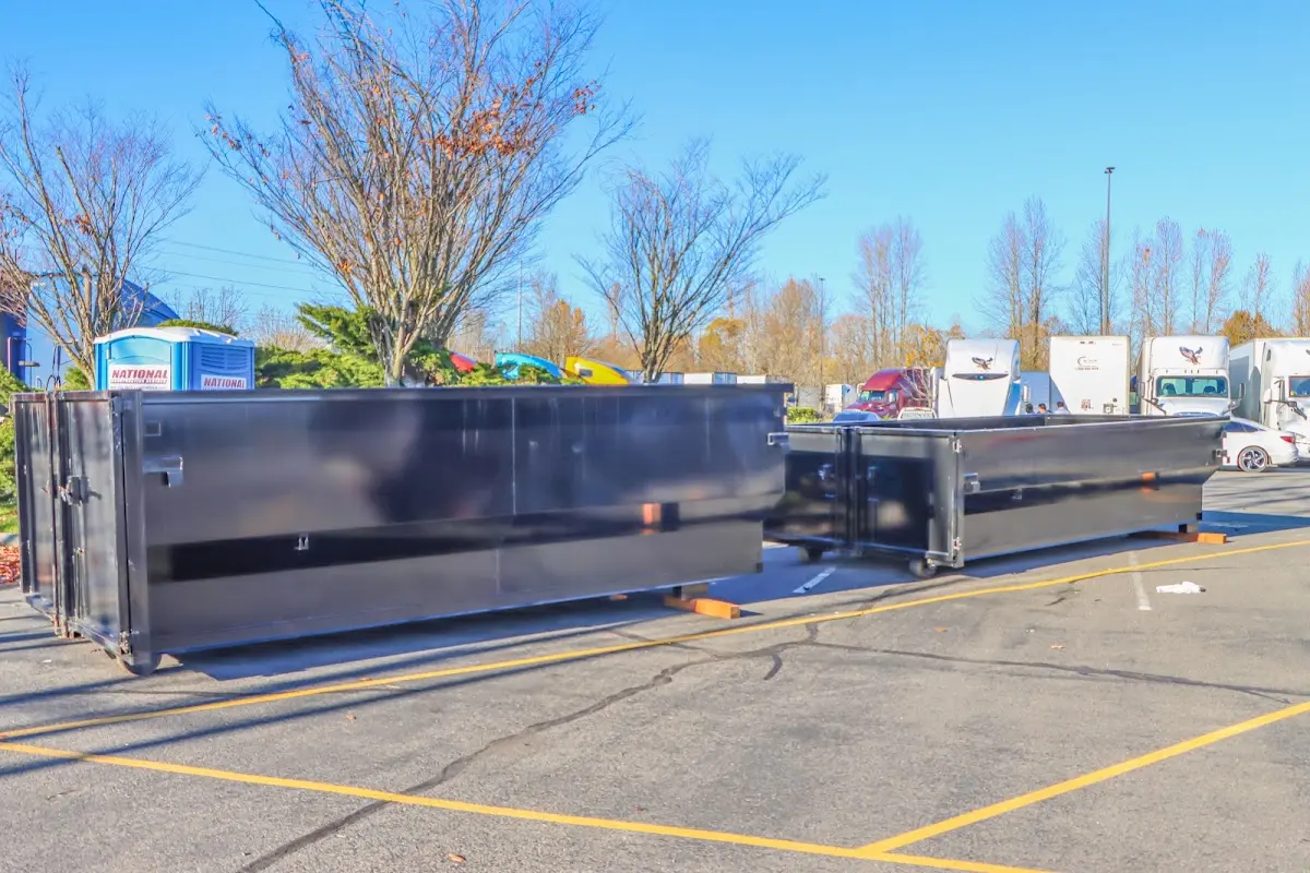 Professional dumpster rental service with roll-off container on residential driveway in Waggaman